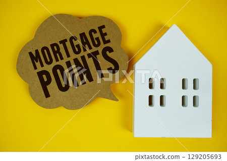 Mortgage Points text with house model on yellow background 129205693