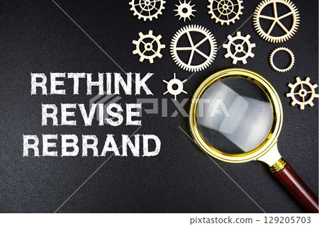 Rethink Revise Rebrand text message with magnifying glass on black background Rethink Revise Rebrand text message with magnifying glass on black background 129205703