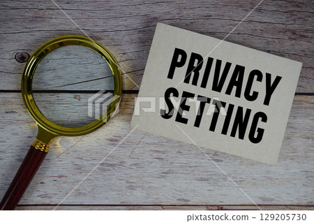 Privacy Setting text written on paper with magnifying glass 129205730