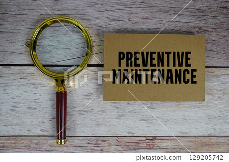Preventive Maintenance text written on paper with magnifying glass 129205742