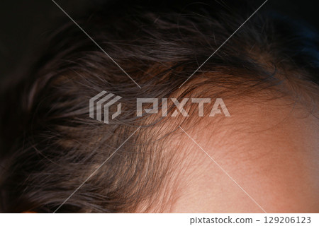 Close-up of little girl textured hair illuminated by soft light Close-up of little girl textured hair illuminated by soft light 129206123