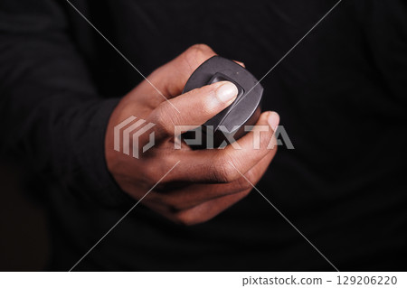 man holding a body spray closeup  129206220