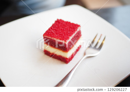Red velvet cake served on a white plate in a cafe 129206227