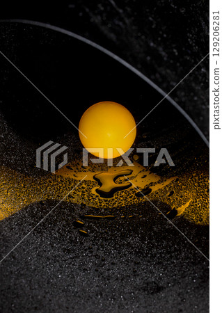 Abstract image with orange ball and water drops on reflective surface Abstract image with orange ball and water drops on reflective surface 129206281