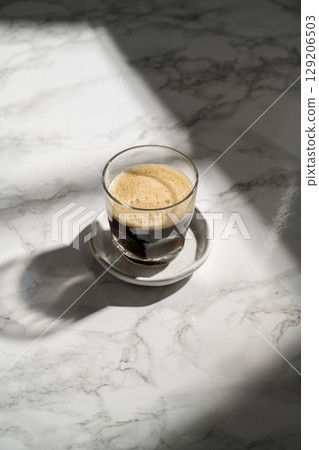 Black hot coffee in a glass, sunlight, lifestyle photo Black hot coffee in a glass, sunlight, lifestyle photo 129206503