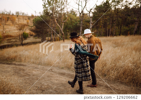 Lovely hipster couple enjoying each other in the autumn park. Nice autumn day. love and lifestyle. Lovely hipster couple enjoying each other in the autumn park. Nice autumn day. love and lifestyle. 129206662