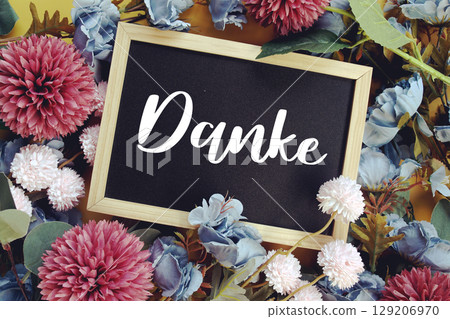 Danke text with flowers decoration on yellow background Danke text with flowers decoration on yellow background 129206970