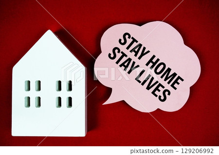 Stay Home Save Lives text message on speech bubble with house model on red background Stay Home Save Lives text message on speech bubble with house model on red background 129206992