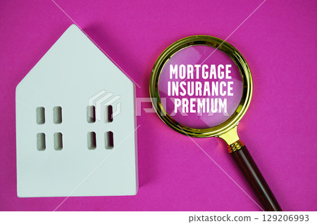 Mortgage Insurance Premium text with house model and magnifying glass on pink background 129206993