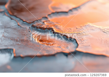 Detailed close-up captures the beauty of frozen water, showcasing soft cracks and unique reflections. The clean aesthetic offers an ideal backdrop for branding opportunities and creative projects 129207369