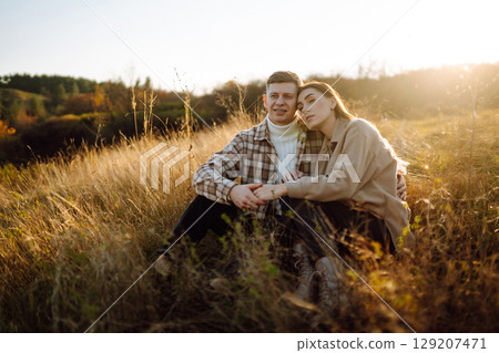 Stylish couple walking autumn weather. People, lifestyle, relaxation concept. Autumn Fashion concept Stylish couple walking autumn weather. People, lifestyle, relaxation concept. Autumn Fashion concept 129207471