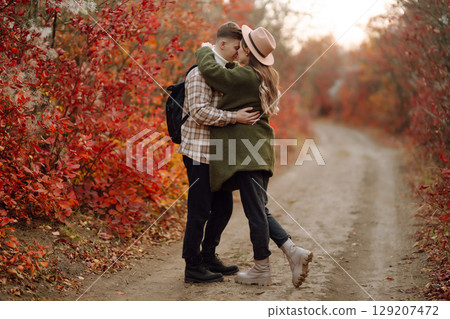 Stylish couple walking and enjoying autumn weather. People, lifestyle, vacations concept. Autumn. Stylish couple walking and enjoying autumn weather. People, lifestyle, vacations concept. Autumn. 129207472