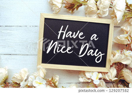 Have a Nice Day text with flower decoration on wooden background 129207582