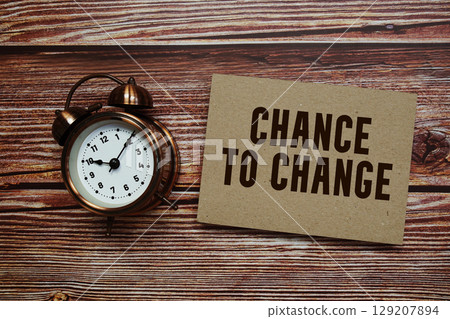 Chance To Change text with alarm clock on wooden background 129207894