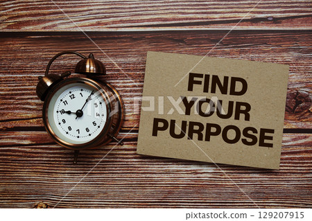 Find Your Purpose text with alarm clock on wooden background Find Your Purpose text with alarm clock on wooden background 129207915