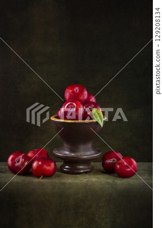Still life with ripe plums on a dark background Still life with ripe plums on a dark background 129208134