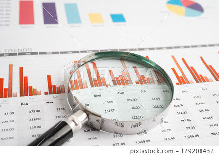 Magnifying glass on charts graphs paper. Financial development, Banking Account, Statistic, Investment Analytic research data economy. 129208432
