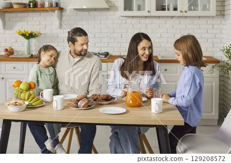 Parents And Children Eating Together At Home 129208572
