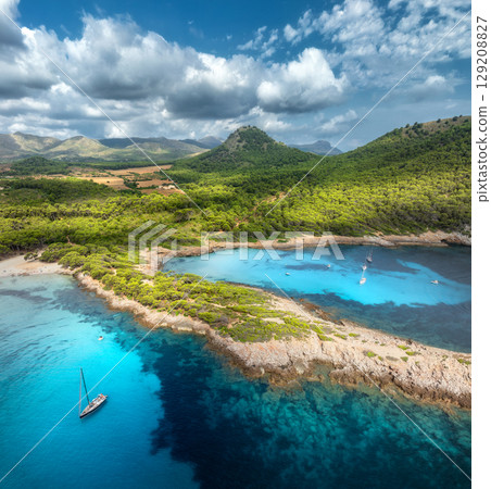 Aerial drone view of boats, rocky coastline with turquoise bays Aerial drone view of boats, rocky coastline with turquoise bays 129208827