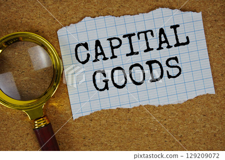 Capital Goods text written on paper with magnifying glass 129209072