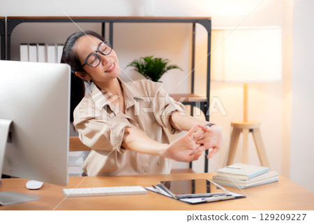 Portrait young asian businesswoman wearing glasses taking a break after overworked. Portrait young asian businesswoman wearing glasses taking a break after overworked. 129209227