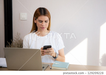 Young caucasian businesswoman texting with serious and concentration with laptop. Young caucasian businesswoman texting with serious and concentration with laptop. 129209228