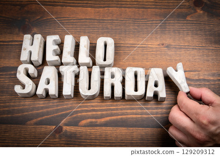 Hello Saturday Concept with Concrete Letters on Wooden Background 129209312