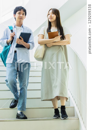 Men and women getting off the stairs Men and women getting off the stairs 129209338