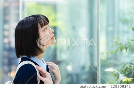 A woman looking up outside the window A woman looking up outside the window 129209341