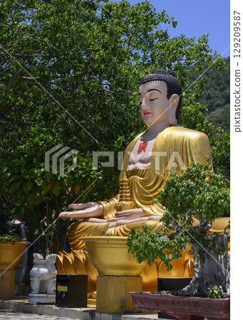 Gilded sculpture of meditating Buddha at Chua Da Bao Monastery 129209587