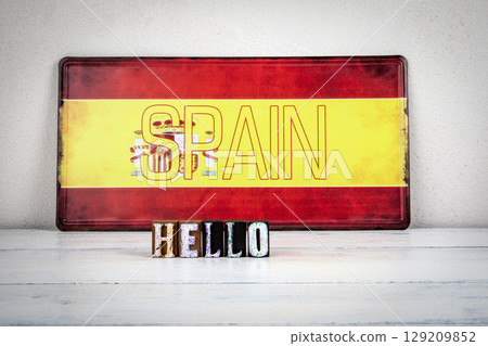 Hello Message with Wooden Letters in Front of Spanish Flag Hello Message with Wooden Letters in Front of Spanish Flag 129209852