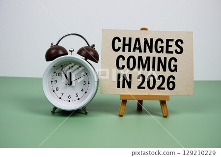 Changes coming in 2026 text on paper card with alarm clock on green background Changes coming in 2026 text on paper card with alarm clock on green background 129210229