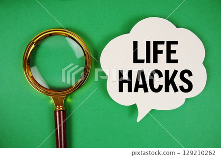 Life Hacks text with speech bubble and magnifying glass on green background Life Hacks text with speech bubble and magnifying glass on green background 129210262