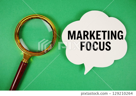 Marketing Focus text with speech bubble and magnifying glass on green background Marketing Focus text with speech bubble and magnifying glass on green background 129210264