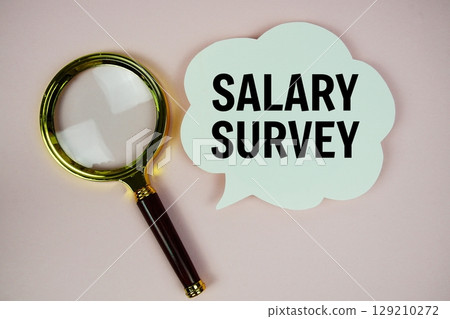Salary Survey text with speech bubble and magnifying glass on pink background Salary Survey text with speech bubble and magnifying glass on pink background 129210272