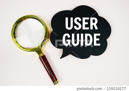 User Guide text with speech bubble and magnifying glass on pink background User Guide text with speech bubble and magnifying glass on pink background 129210277