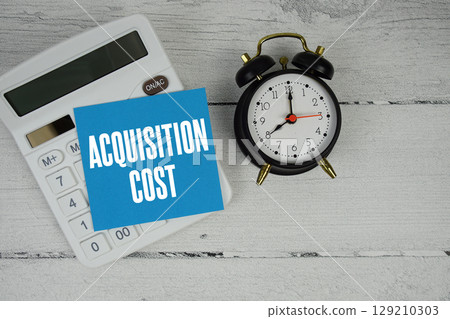 Acquisition Cost text with calculator and alarm clock on wooden background Acquisition Cost text with calculator and alarm clock on wooden background 129210303