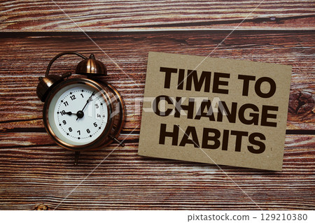 Time to Change Habits text with alarm clock on wooden background 129210380