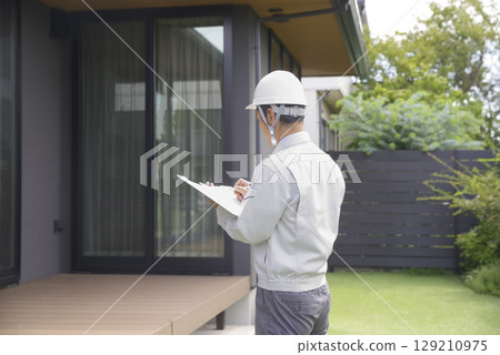 Male architect checking a home Male architect checking a home 129210975