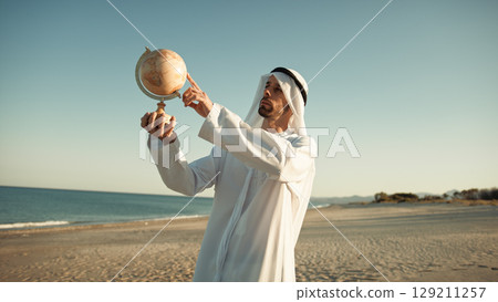 Sheik Admiring And Moving A Globe Sheik Admiring And Moving A Globe 129211257