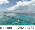 Aerial shot of the long Ikema Bridge connecting Miyako Island and Ikema Island in Okinawa Prefecture, where the beautiful sea stretches out, taken using a drone 129211375