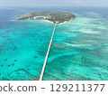 Aerial shot of the long Ikema Bridge connecting Miyako Island and Ikema Island in Okinawa Prefecture, where the beautiful sea stretches out, taken using a drone 129211377