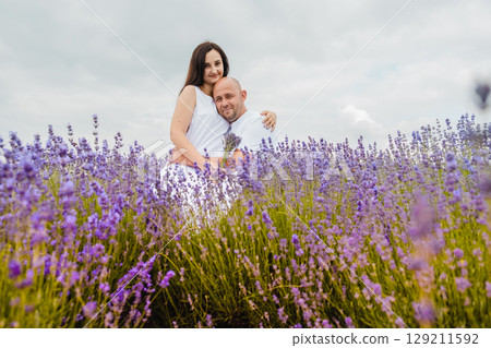 A boy and a girl in love embracing in a lavender field 129211592