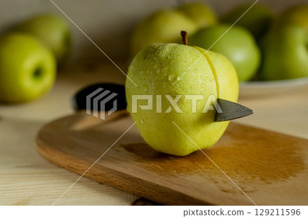 A knife in an apple A knife in an apple 129211596