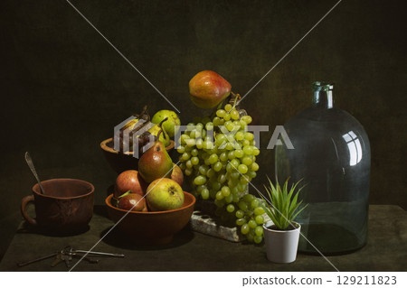 Still life with fruits and dishes on the table Still life with fruits and dishes on the table 129211823