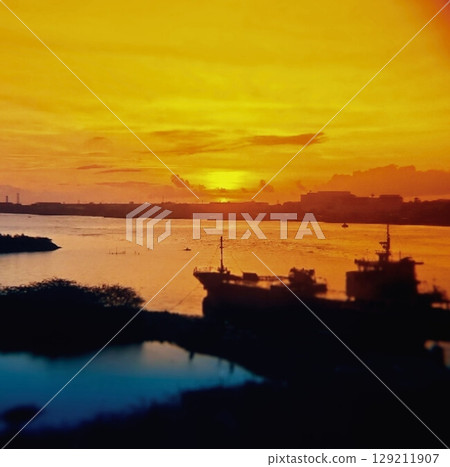 Sunrise sky and a ship floating on the sea Sunrise sky and a ship floating on the sea 129211907