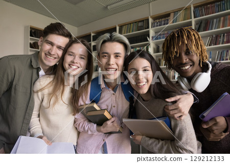 Joyful multiracial diverse teenage students hug for funny group portrait Joyful multiracial diverse teenage students hug for funny group portrait 129212133
