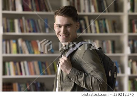 Smiling motivated student guy with stylish backpack looking at camera 129212170