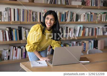 Woman using laptop, enjoy work results, achievements and productive workday 129212209