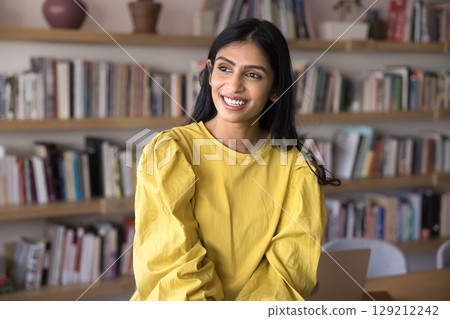 Pensive Indian woman take break in office or library Pensive Indian woman take break in office or library 129212242